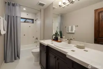Light and bright full bath continues with custom style and refined design.