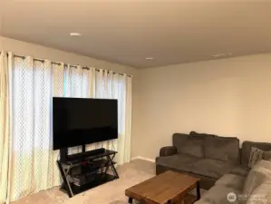 Large living room with open floor plan & view of fenced back yard