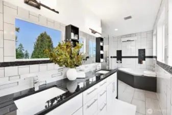 Modern primary bath with double vanity, jetted tub, and sleek finishes