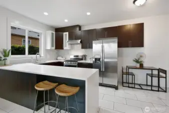 ADU kitchen with island seating and stainless appliances