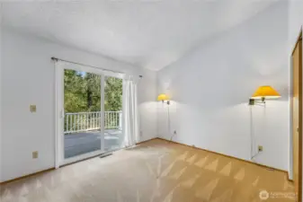 Primary bedroom with slider leading to the deck.