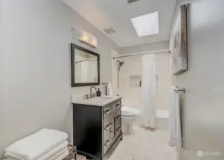 Upstairs main bath with tile surround and heated tile floor.