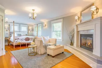 The Primary Suite is on the upper level and was created by the major addition.  This room is huge, with space for a King bed and nightstands surrounded by garden  facing windows. A cozy gas fireplace is the perfect spot for reading or a nightcap.