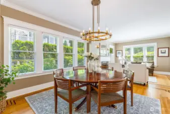 This dining room can easily host a large crowd.  It's surrounded by windows with an outlook to the gardens, and features a stunning new RH chandelier and matching wall sconces.