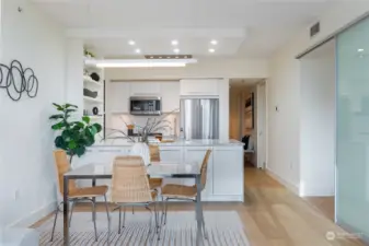 Beautiful dining under custom chandelier; floating on beautiful wide-plank European white oak flooring.