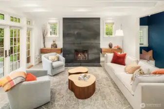 Cozy Den with porcelain tile floor and fireplace opens to the garden