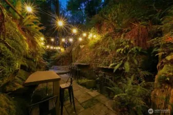 Monolith Chuckanut sandstone "Grotto" with tables and chairs, lighting and fire pits