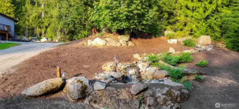 Greeted by cascading water feature as you enter the property