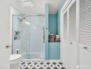Bath with walk in shower.