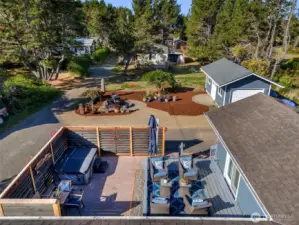 Secluded outdoor space with patio, deck, and hot tub.