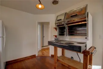 Two working ovens and four burners.  The hallway to the bedrooms is on the other side of the kitchen.