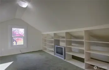 Upstairs bedroom with built in bookshelves.