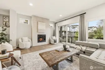 Main floor living room anchored by a modern gas fireplace
