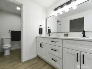 Primary bath. Shower.  New cabinets with two sinks and Quartz counter tops. Full length mirrow. Designer lighting.