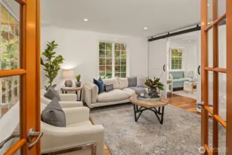 Formal living room with french doors and sliding barn doors to separate from the kitchen.