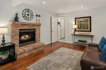 Family room with raised-hearth propane fireplace.