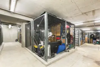 Storage locker in garage close to parking stall.