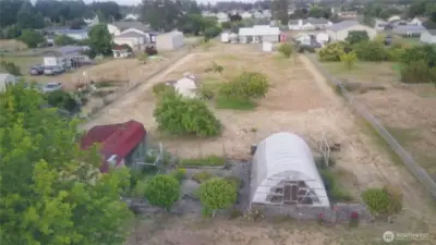 drone view multiple sheds and greenhouse