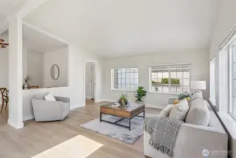 The floor plan offers versatile living spaces, perfect for both relaxation and entertaining. The living room is bathed in natural light, creating a warm and inviting atmosphere.
