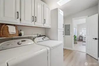 The laundry room has access to the garage, living room, and guest bathroom.