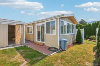 This is the fenced side of the backyard, which offers access to the bonus room and two sheds that can be used for storage or as a workshop.