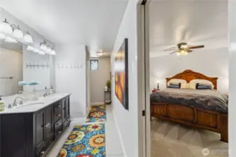 Downstairs bathroom with double sink vanity and walk-in shower.