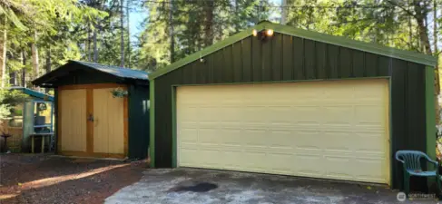 2 car garage and exterior of storage shed on the left
