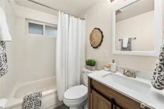 Beautifully updated full bathroom with modern touches and fixtures.