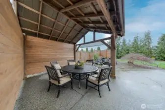 Gazebo overlooking water feature in backyard.  Staged Furniture