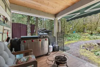 Covered back porch with custom design. Outdoor cooking. Propane fire pit. Comfy seats for conversation time any time of year.