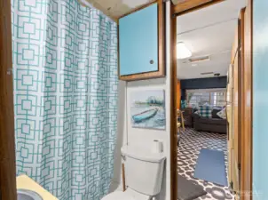 Bathroom just off the kitchen connects to the bedroom.