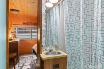 Bathroom just off the kitchen connects to the bedroom.