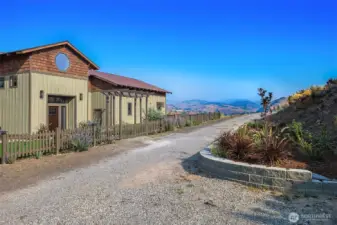Large circular driveway with low maintenance landscape and firewise areas