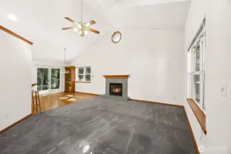Spacious living and dining area with cathedral ceilings and gas ( propane) fireplace