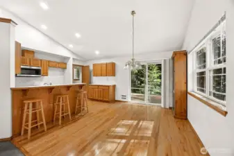 Dining room and kitchen with hardwood floors