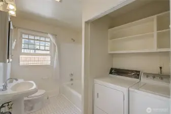 Full bathroom on the second floor, featuring a washer and dryer
