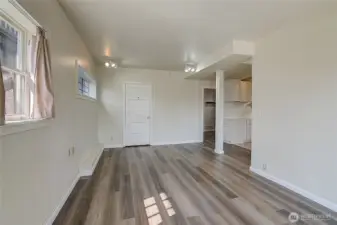 Lower unit living room is adjacent to two bedrooms, the kitchenette, and the second full bathroom
