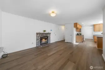 Family room with wood fireplace and door leading out to the level huge fully fenced backyard. Enjoy many nights cuddling up to the fireplace.