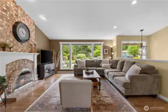 A classic brick walled fireplace serves as a charming focal point, adding warmth and character to this inviting room.