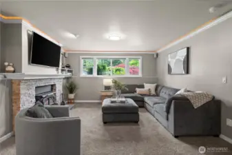 Head down to the lower level, where a spacious bonus room offers a private retreat—perfect for unwinding, cozying up by the wood-burning stove, or enjoying as a media room.