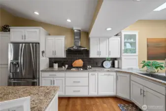 The fully permitted kitchen remodel showcases classic shaker-style cabinetry, sleek slab granite countertops, and stylish subway tile accents. Just off the kitchen, a cozy family room offers seamless access to a spacious outdoor balcony—perfect for relaxing or entertaining.