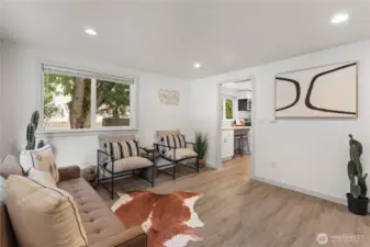 spacious living room with plenty of wall space for mounted tv, cute dining tablem sectional couch?