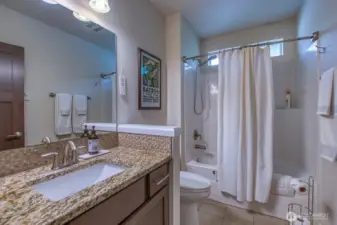 Guest bath with tub and shower combo.