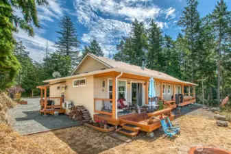 Covered porch runs the full length of the west side of the house for enjoyable outdoor living.
