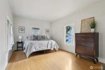 Primary bedroom has bamboo flooring windows on all three walls, so is absolutely drenched in natural light