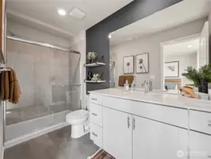 En-suite bath boasts glass-enclosed shower with tile surround, quartz vanity, and sleek fixtures for a spa-inspired finish. Pictures are for representational purposes only, colors and features may vary.
