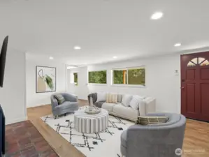 Lower level family room with doorway to backyard and covered patio. Virtually staged.