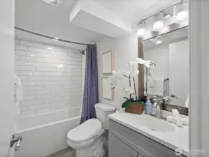 Lower level full bathroom with deep tub and shower head.