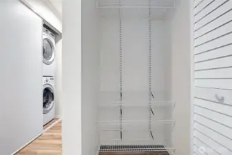 Entryway coat closet with built-in shelving.