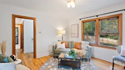 The living room windows face Porter Street, framed by the neighbor’s beautiful tree canopy that adds natural beauty and an amazing sense of privacy.